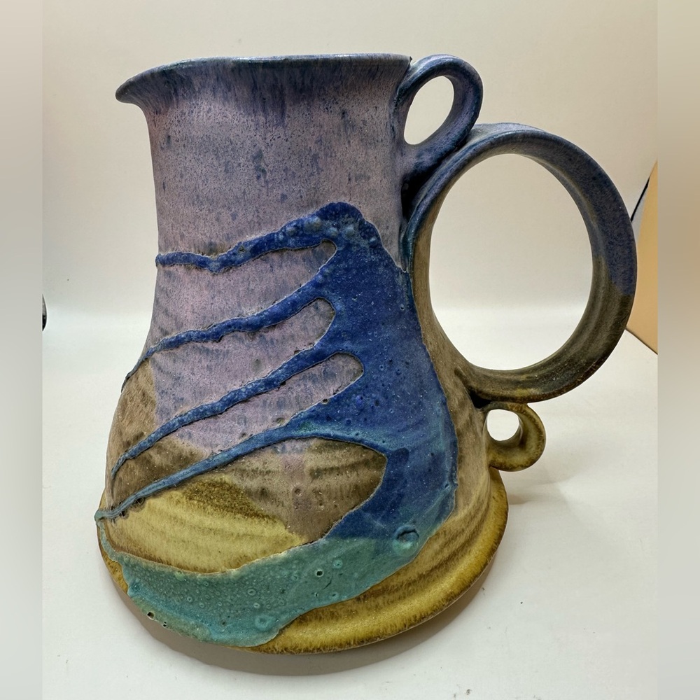 DE Benedict Studio Pottery Pitcher. Signed. Tan with Purple, Blue, and Green.